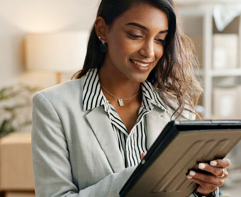 Smiling woman working on tablet