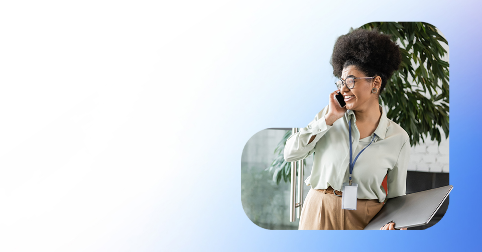 Business woman taking a phone call while holding a laptop