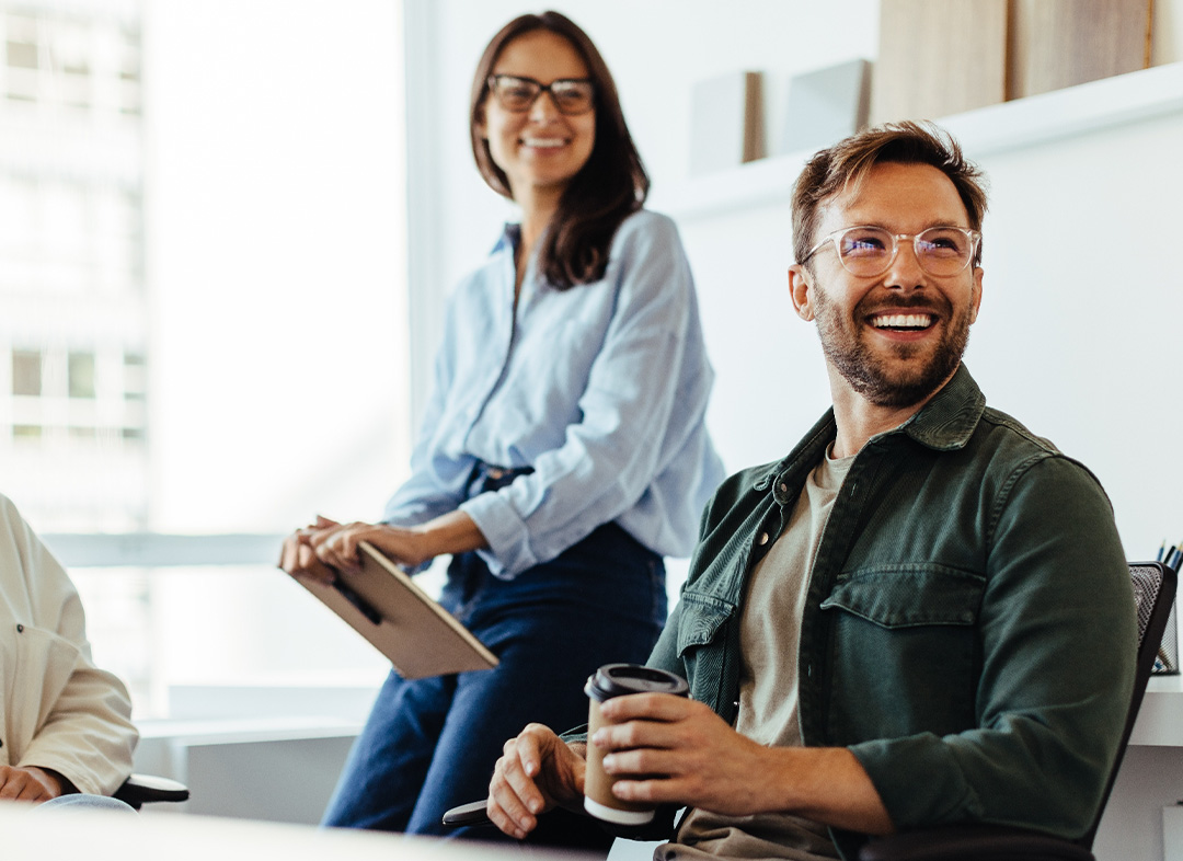 Man and woman smiling during a meeting