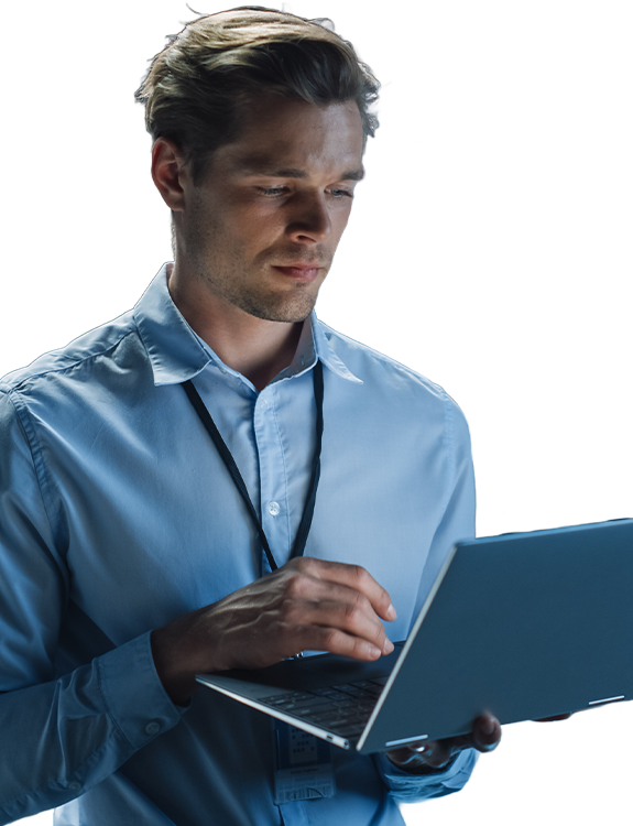 Man using laptop in data centre