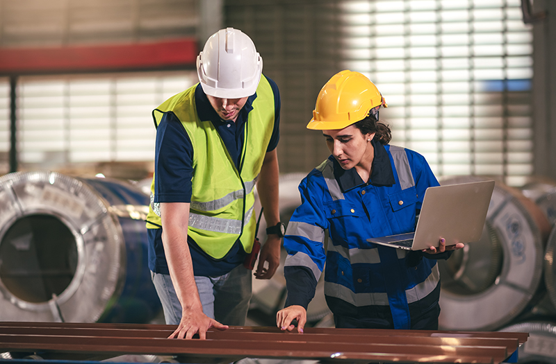 Two teammates working together in a manufacturing facility