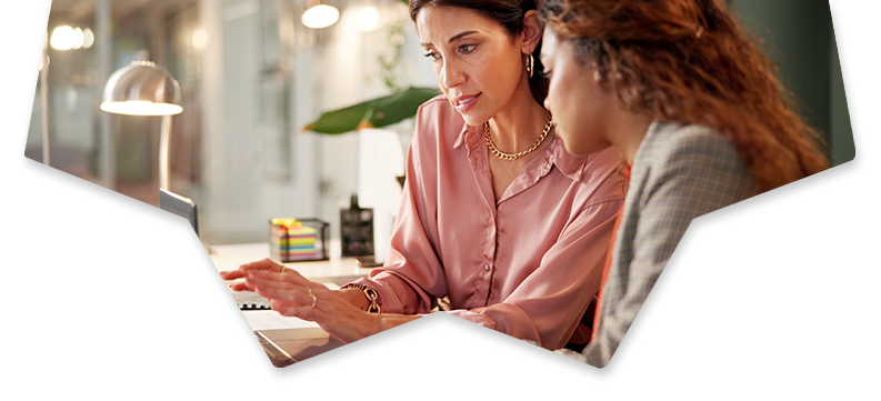 Two women working together on a laptop