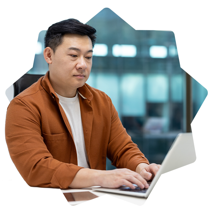 Man looking down at the laptop in office