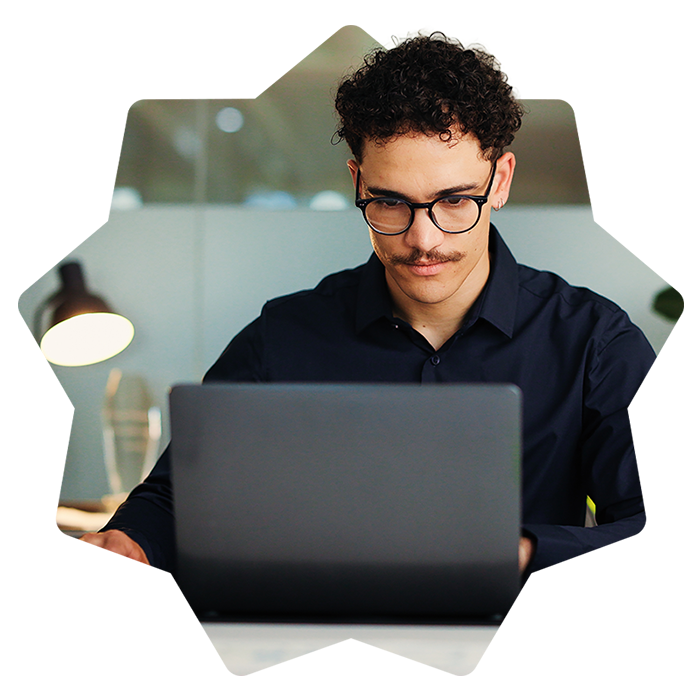 Young man using laptop in modern office