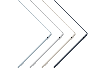 In an open photo in the Photos app on MacBook Air, a person is standing on a desert dune and a small distracting object is highlighted for removal by the Apple Intelligence Clean Up tool