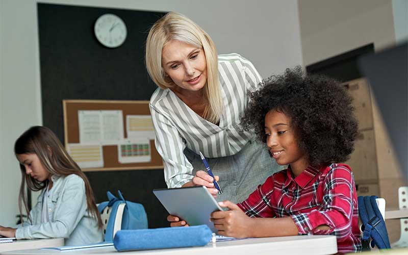 Girls working in a classroom on tablets