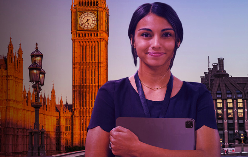 Smiling woman standing in front of the clock tower