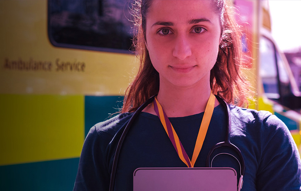 Doctor standing in front of an ambulance