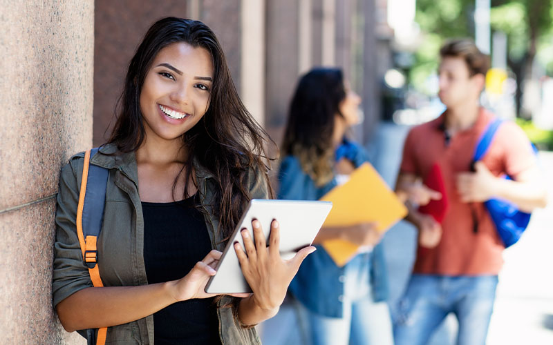 Student smiling with tablet