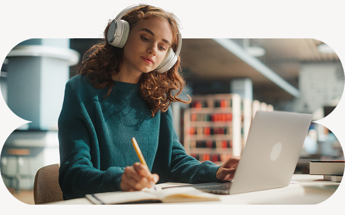 Student with headphones working on laptop