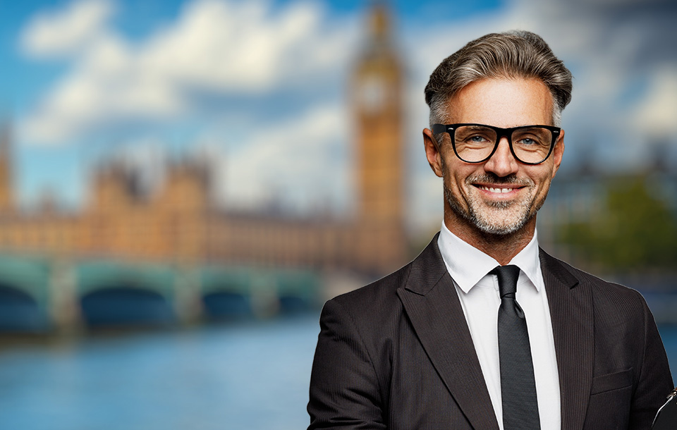 Suited man smiling in front of parliament Suited man smiling in front of parliament