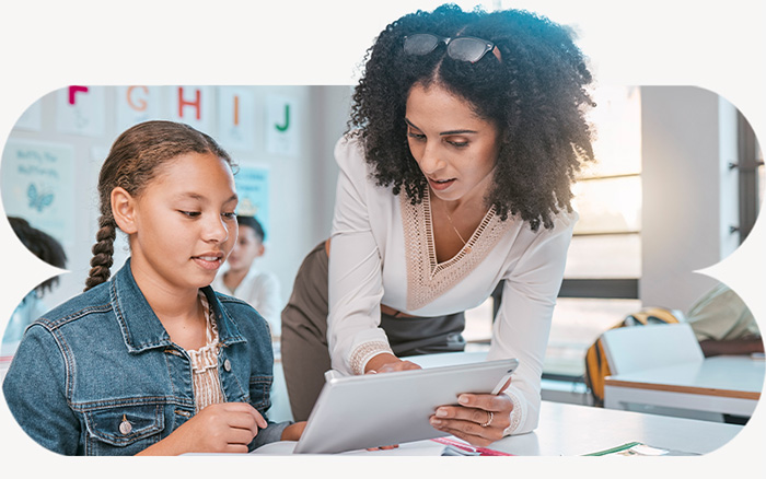 Teacher helping a student with tablet