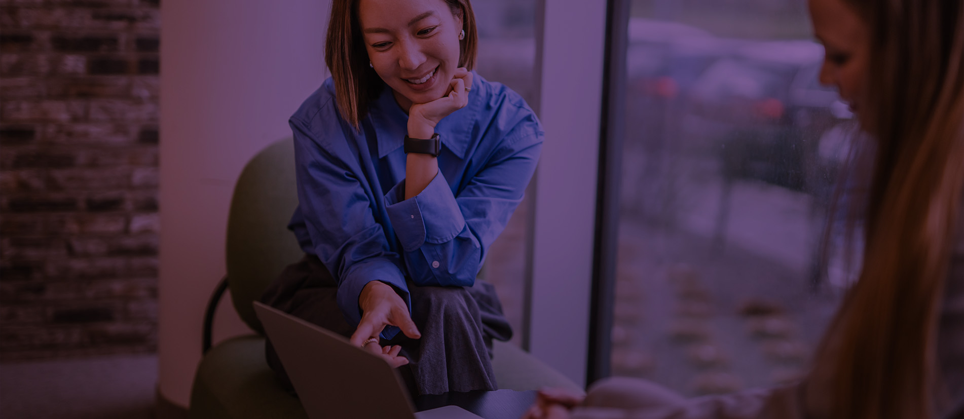 Teammates smiling while in a meeting