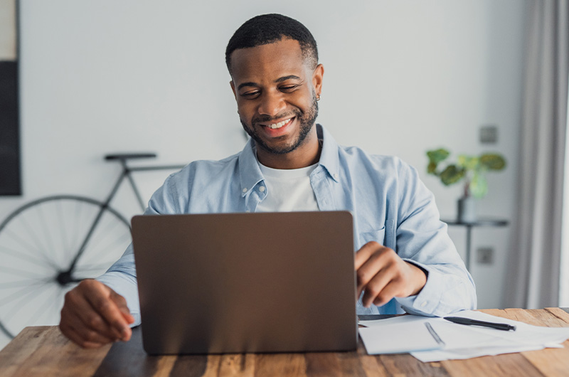 Buy Smarter. Spend Less. Renew With Confidence. Man working on laptop