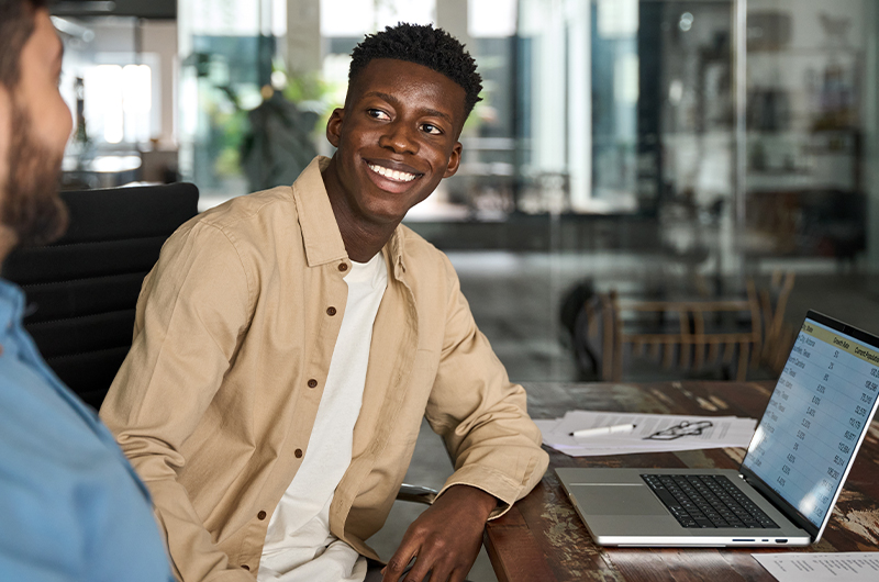 Business professional smiling while working on laptop