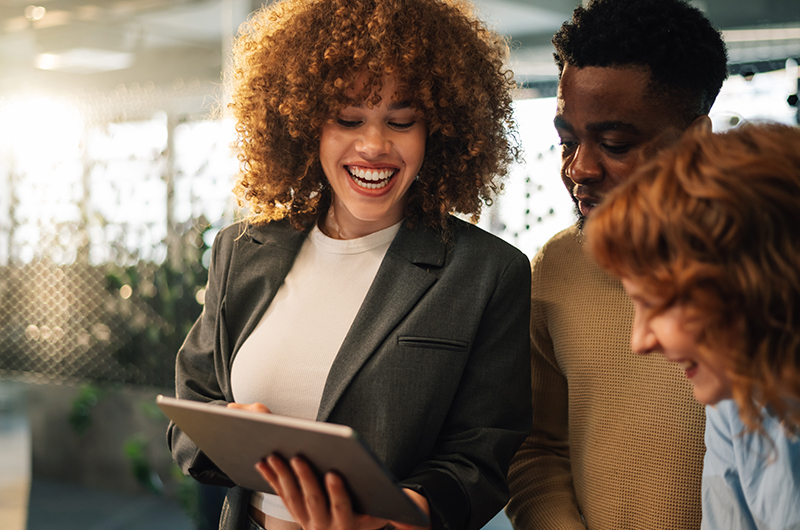 Teammates collaborating while using a tablet