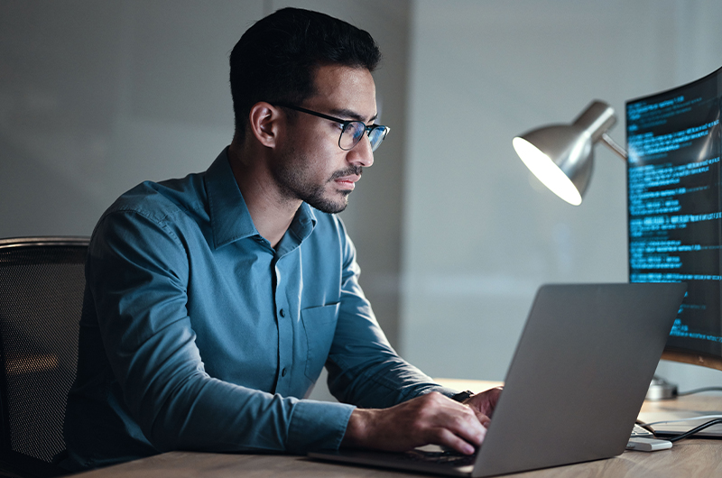 Software engineer coding on a laptop