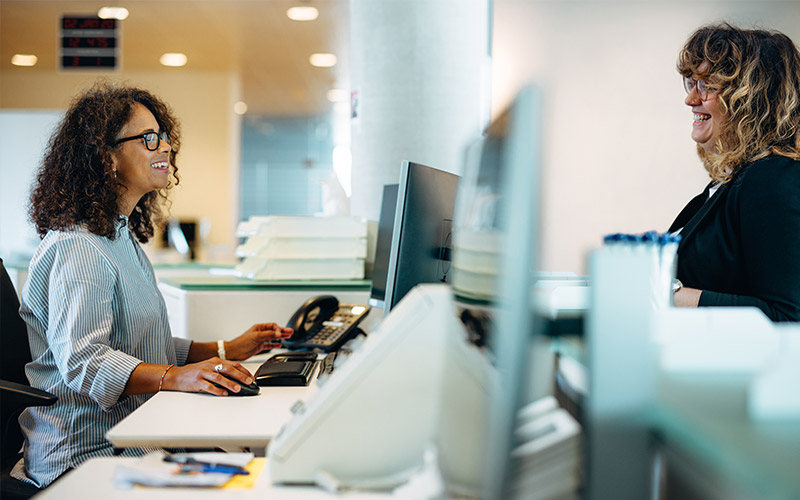 Woman on phone sitting with laptop