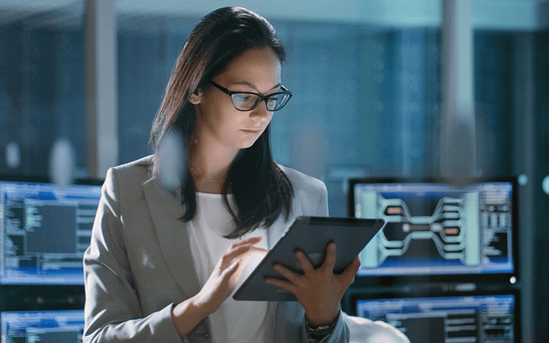 Woman looking at tablet in control room