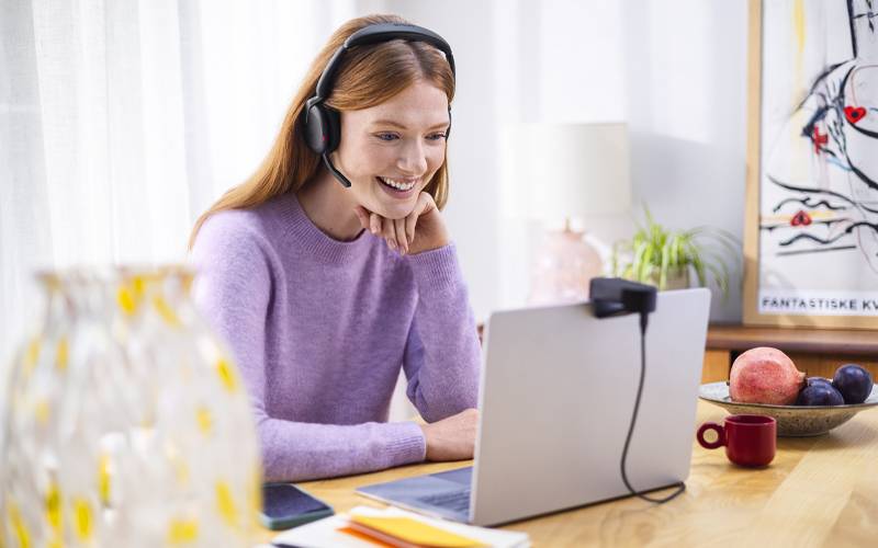 smiling woman wearing evolve2 headset