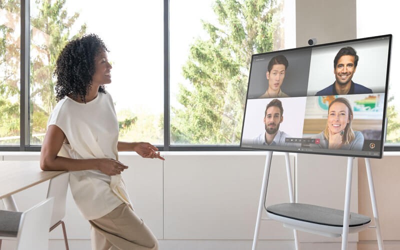 Woman using Surface Hub 2S for web meeting