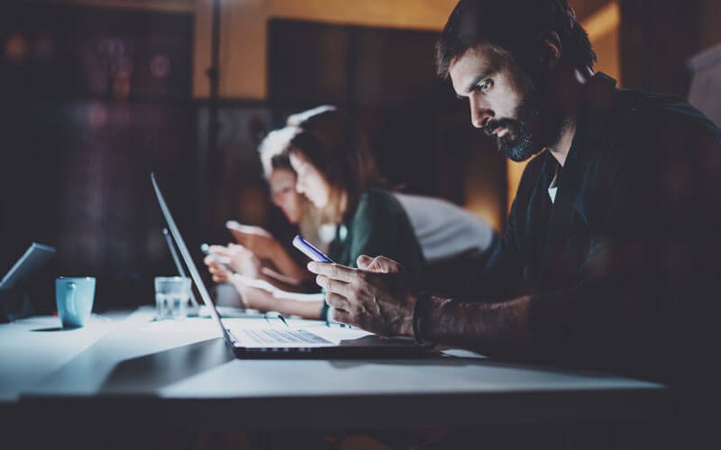 Man working on technology devices