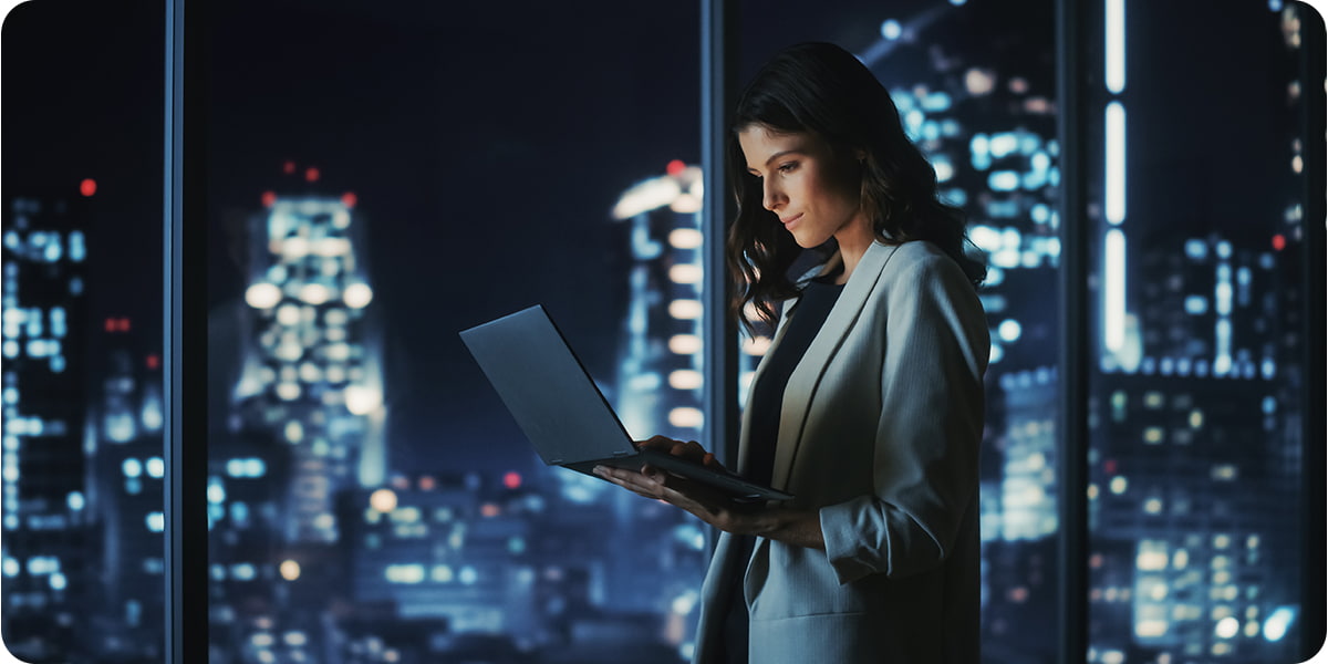 Woman working on a laptop at night