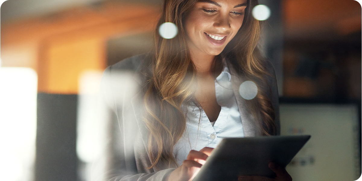 Woman smiling while working on a mobile device