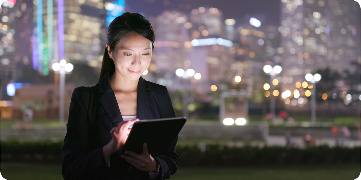 Smiling woman working remotely on a mobile device