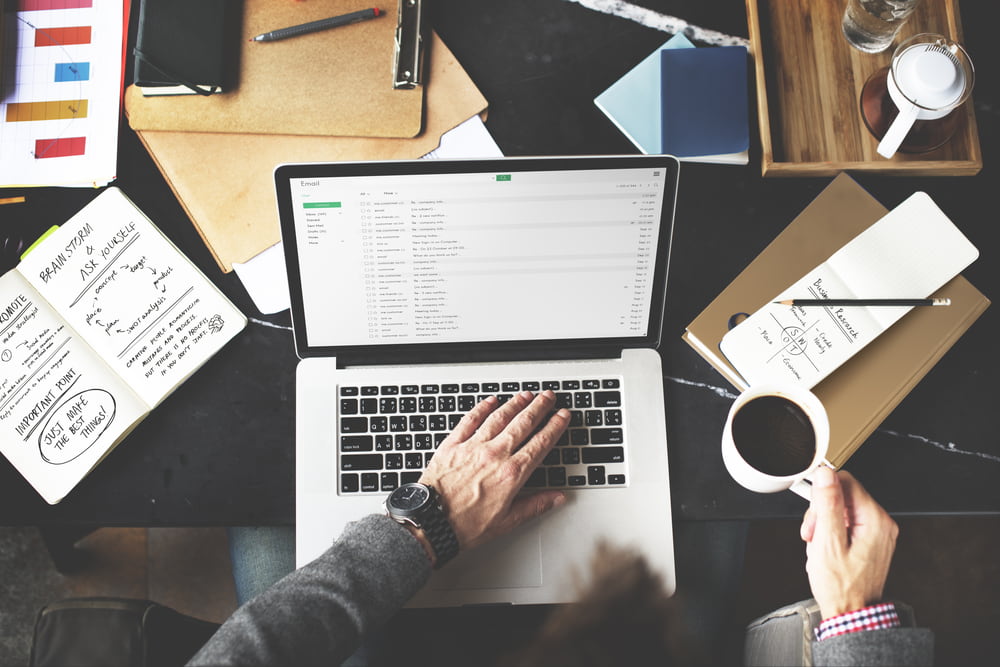 Man holding a cup of coffee while working