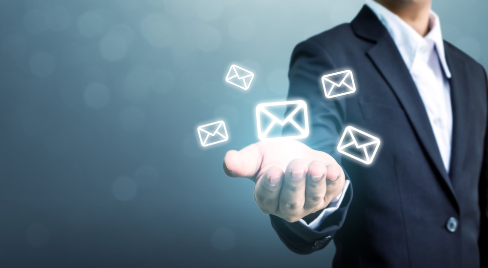 Man holding email icons