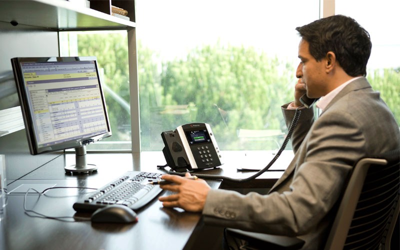 Business man using Poly phone