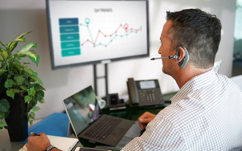 Business man using Poly phone