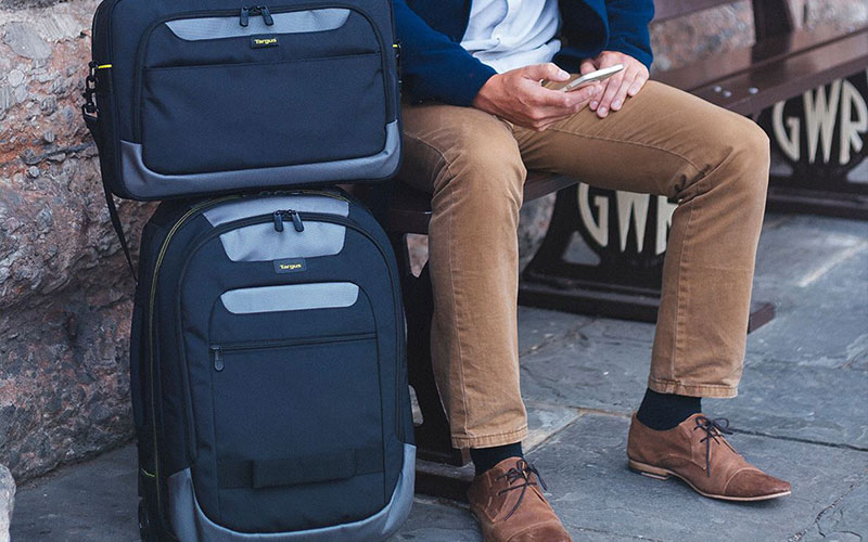 Man sat waiting with his Targus laptop luggage