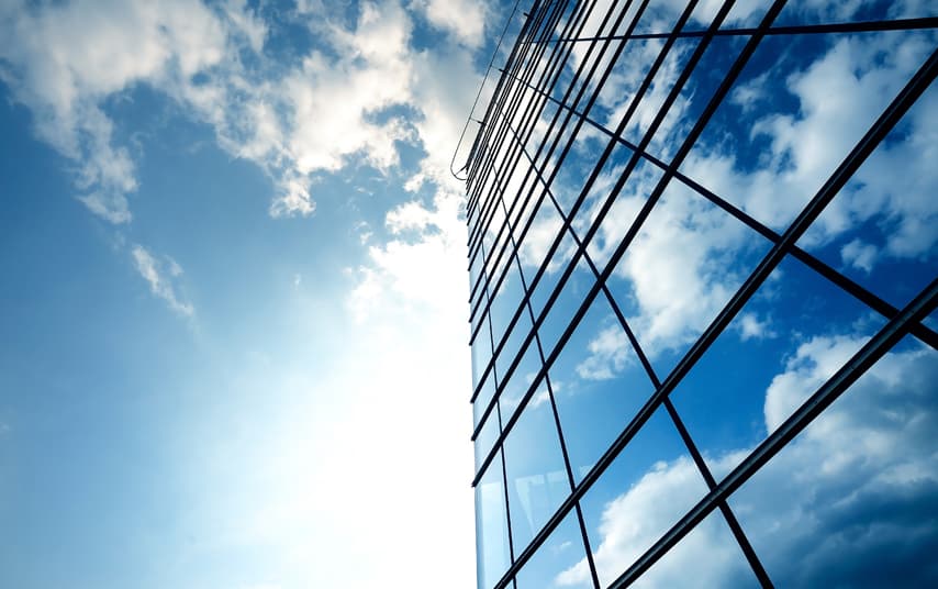 Building with sky on top reflecting in the windows