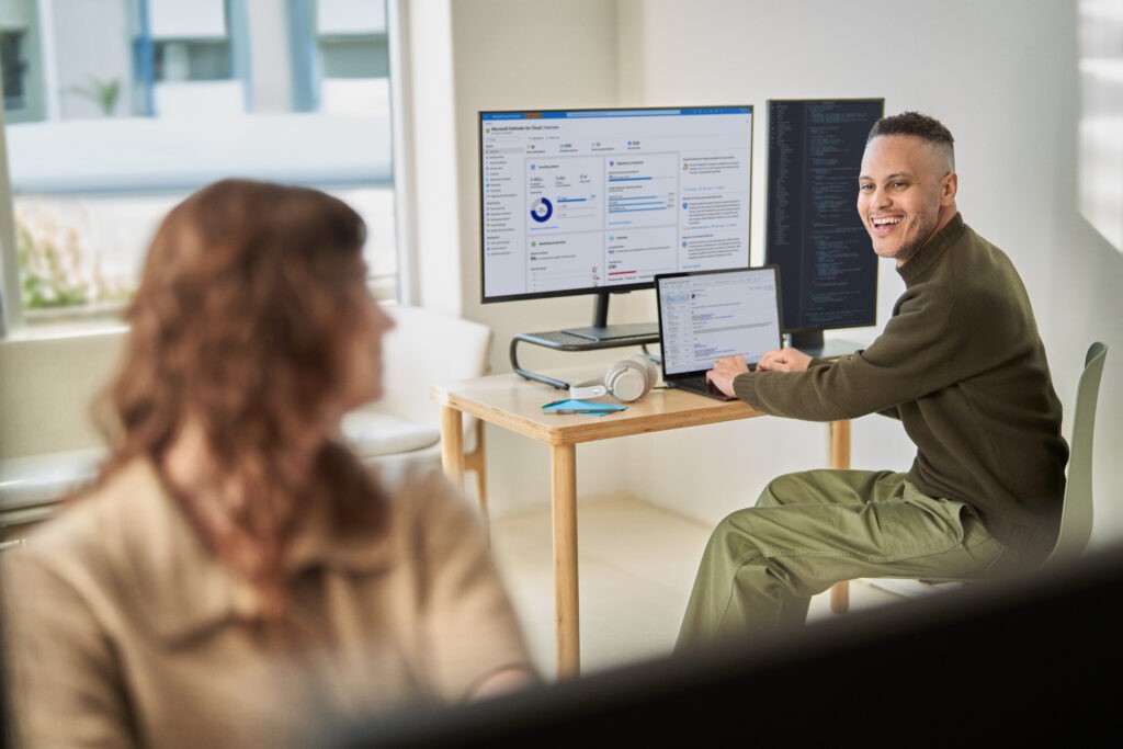 Person using Microsoft CoPilot software on multiple screens for enhanced productivity and multitasking.