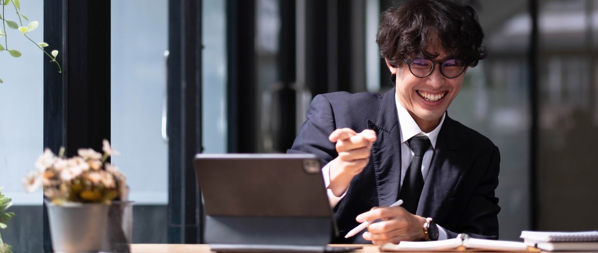 Man in a suit smiling on a video call
