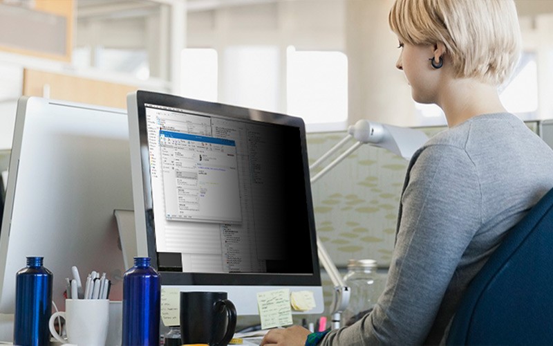 Keep visual hackers in the dark woman working with a black privacy filter