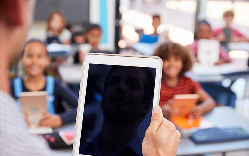 Woman on phone sitting with laptop