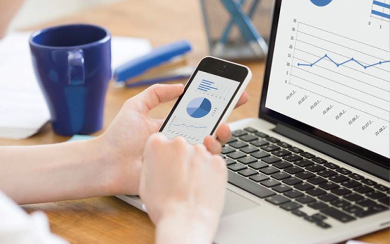 Explore our Subscription Based Computing Someone using an iPhone while on a MacBook