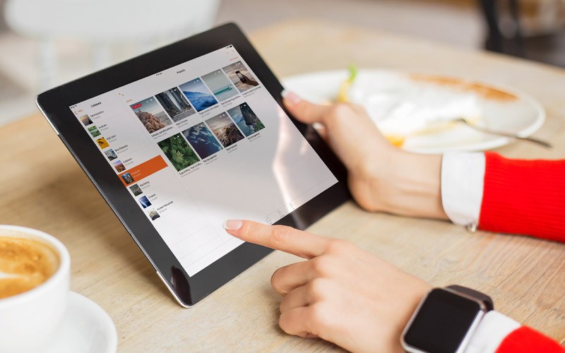 Real-Time Sales Enablement Capabilities In A Simple, Easy- To-Use Environment Someone using an iPad