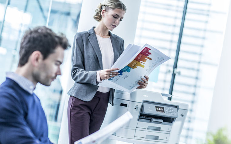 Woman with paper and printer