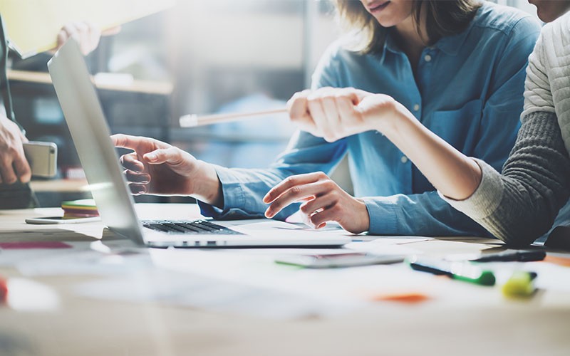 Small business is personal Working at desk with laptop