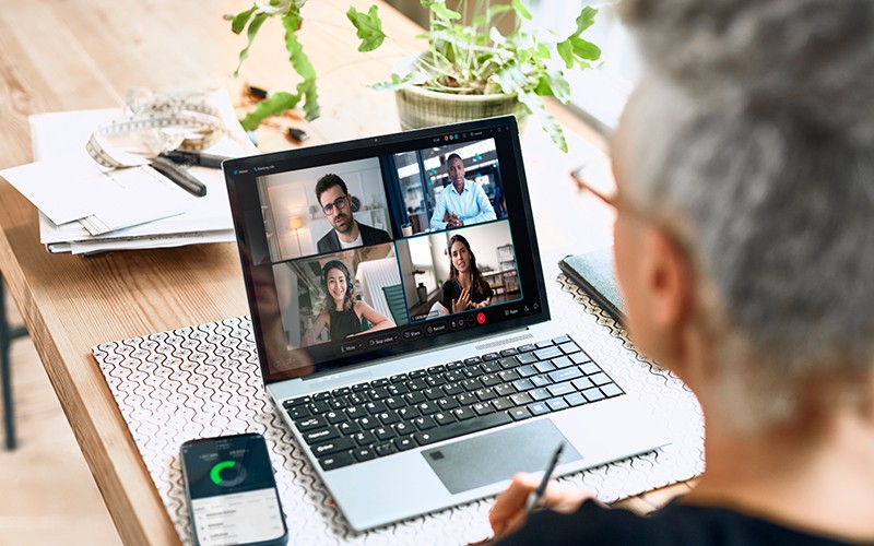 Hybrid work for small and medium business Back of someone's head while taking part in a video call