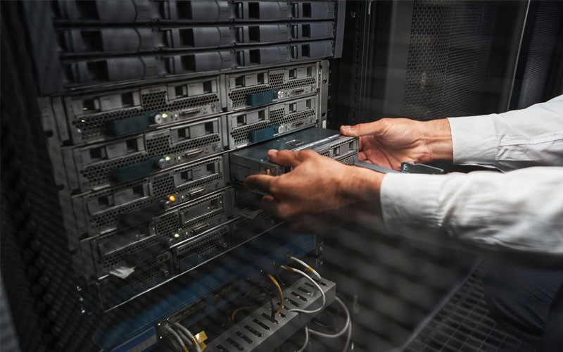 Close of hands pulling a server out of a rack