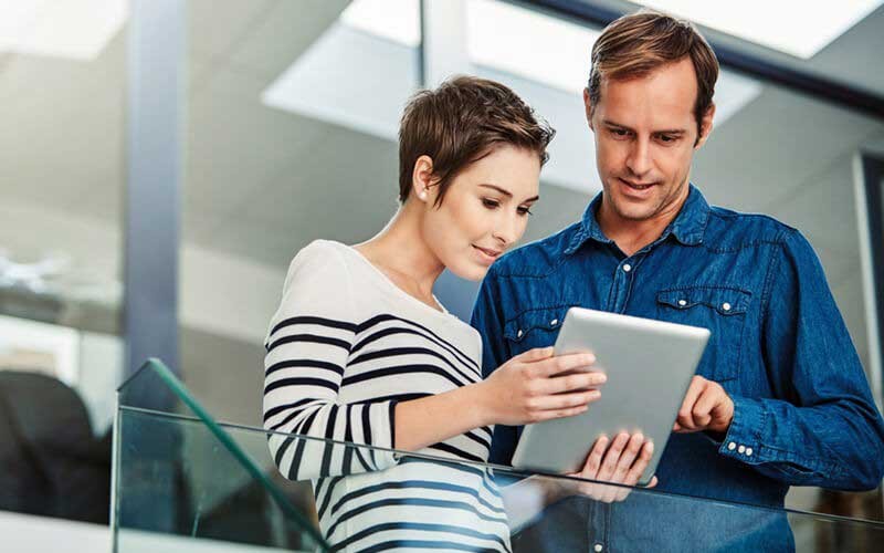 Collaboration solutions from Cisco Two users looking at tablet device