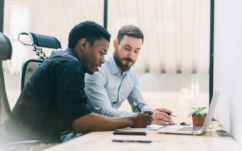 Cisco Security Enterprise Licensing Agreement Small meeting collaborating over laptop screen