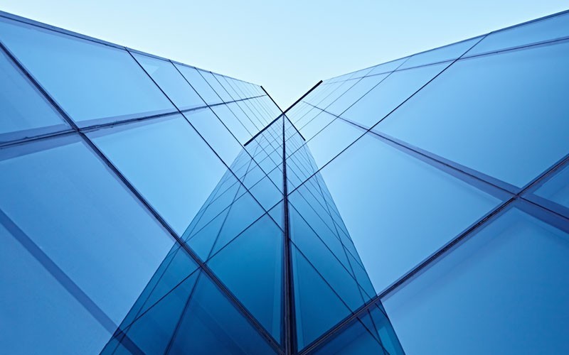 Cloud services for all environments Upward angle of skyscraper glass building