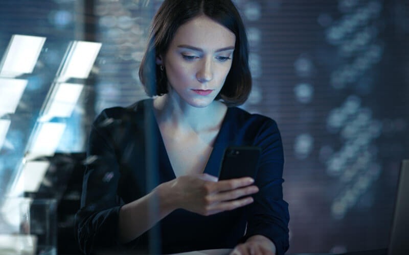 Dell virus and phishing protection to secure email Woman looking at mobile device