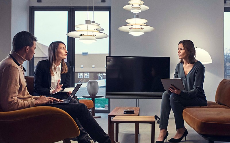 Premium audio tools for all types of meeting rooms Group of colleagues having a meeting around a table